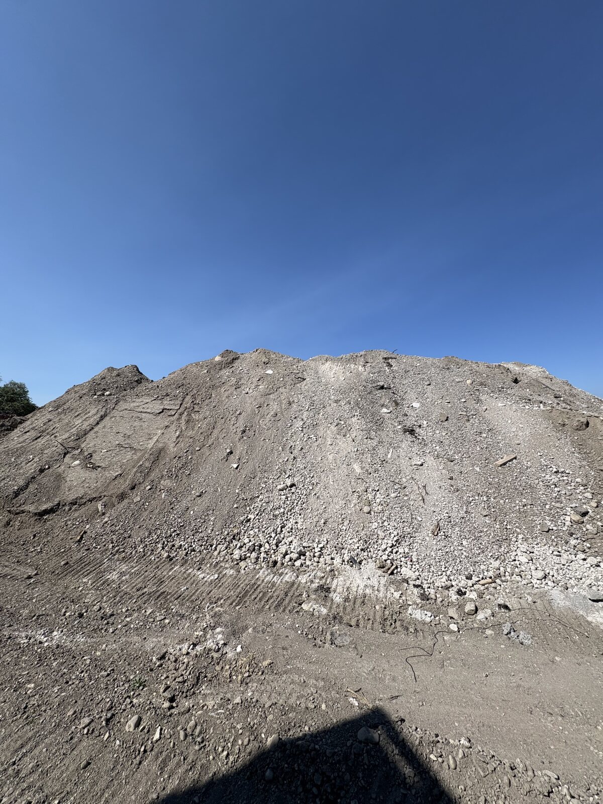 Clean aggregate and pit-run material stockpiled at the yard