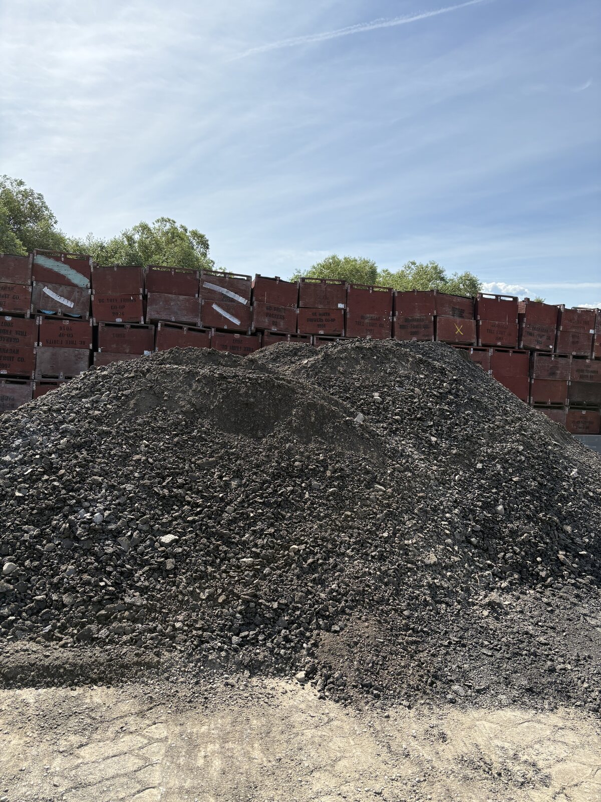 Dark asphalt millings stockpiled at the yard